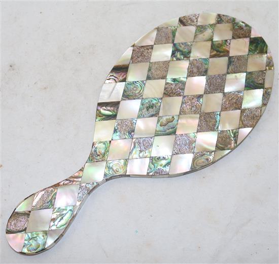 A Victorian hand mirror, completely veneered in Mother of Pearl